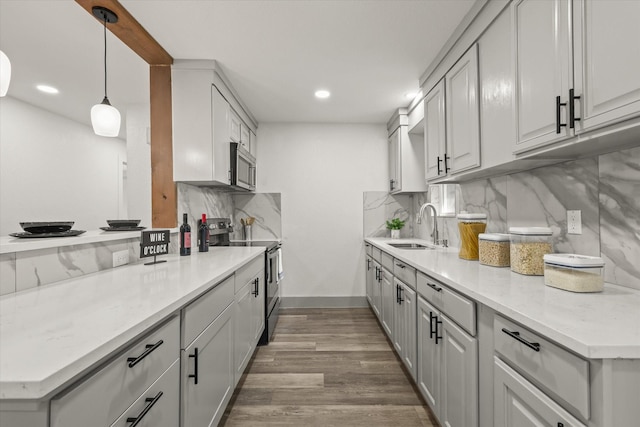 4807 Bedford Dr, Mesquite, TX 75150 - kitchen with stainless steel appliances, decorative backsplash, light countertops, wood finished floors, and recessed lighting