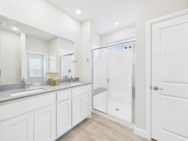 1016 Croxley Way, Fort Worth, TX 76247 - bathroom with wood finished floors, double vanity, a shower stall, and recessed lighting