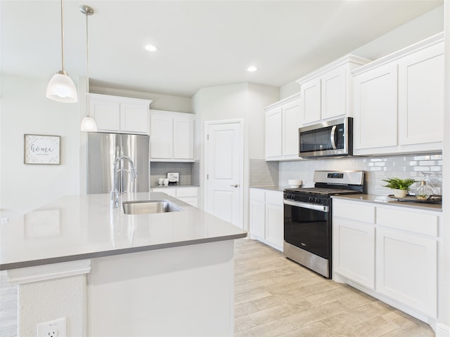 1016 Croxley Way, Fort Worth, TX 76247 - kitchen with stainless steel appliances, backsplash, light wood-style floors, white cabinetry, and decorative light fixtures