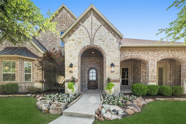 1861 Sand Creek Dr, Prosper, TX 75078 - doorway to property with brick siding, a shingled roof, and a yard