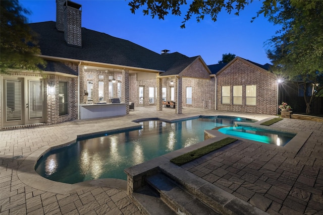 1861 Sand Creek Dr, Prosper, TX 75078 - view of pool featuring an outdoor kitchen, a patio area, and a pool with connected hot tub