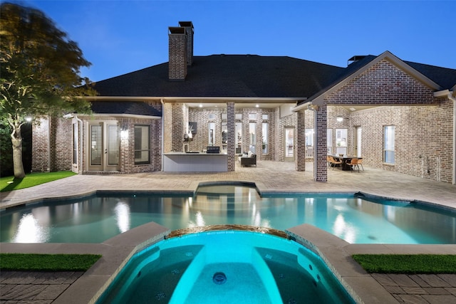 1861 Sand Creek Dr, Prosper, TX 75078 - view of swimming pool with a patio area, a pool with connected hot tub, and an outdoor kitchen
