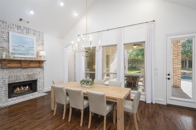 1861 Sand Creek Dr, Prosper, TX 75078 - dining room with high vaulted ceiling, dark wood-style flooring, a fireplace, recessed lighting, and a chandelier