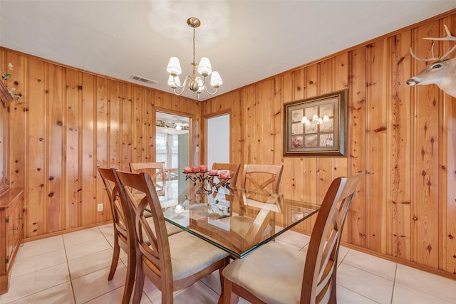 1102 Griffith Ave, Terrell, TX 75160 - dining area featuring a chandelier, wood walls, and light tile patterned floors