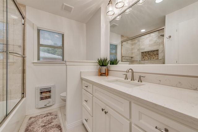 1102 Griffith Ave, Terrell, TX 75160 - full bath with heating unit, vanity, tile patterned floors, enclosed tub / shower combo, and recessed lighting