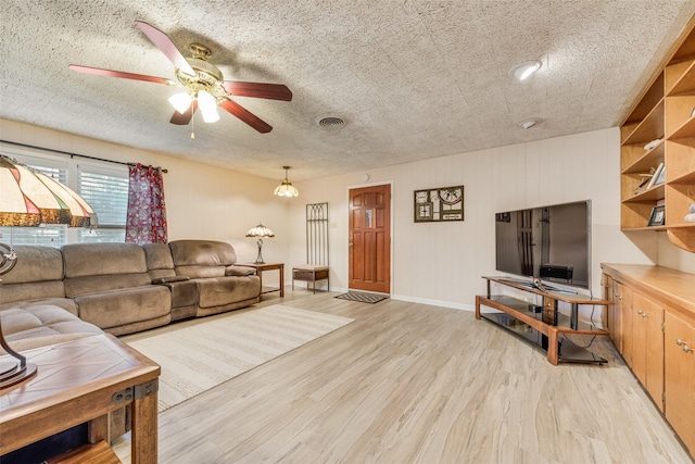 1102 Griffith Ave, Terrell, TX 75160 - living area with a ceiling fan, light wood-style floors, and a textured ceiling