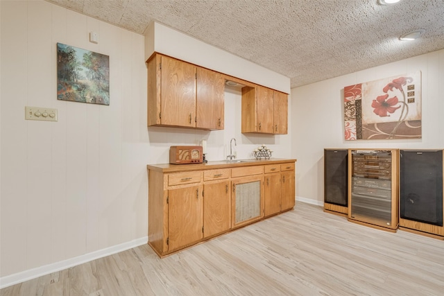 1102 Griffith Ave, Terrell, TX 75160 - bar area featuring beverage cooler and light wood-style flooring