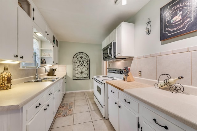 1102 Griffith Ave, Terrell, TX 75160 - kitchen featuring white appliances, white cabinetry, light countertops, and decorative backsplash