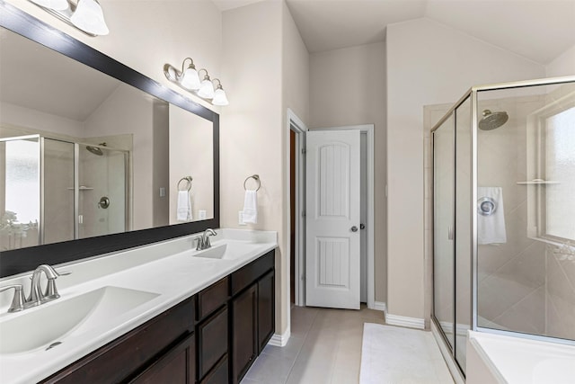 11513 Champion Creek Dr, Frisco, TX 75036 - bathroom with a shower stall, tile patterned floors, double vanity, vaulted ceiling, and healthy amount of natural light