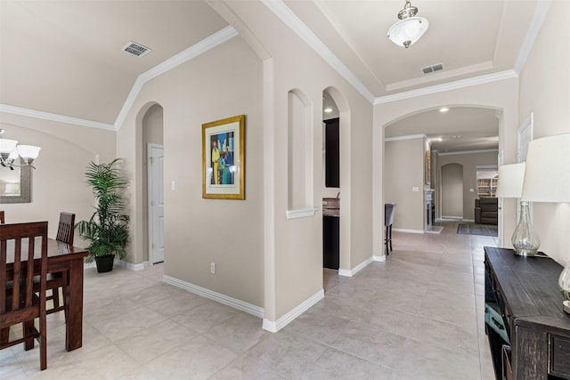 11513 Champion Creek Dr, Frisco, TX 75036 - hallway featuring crown molding, light tile patterned floors, a chandelier, and arched walkways