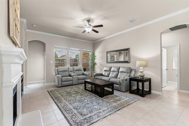 11513 Champion Creek Dr, Frisco, TX 75036 - living area featuring ceiling fan, arched walkways, light tile patterned flooring, a fireplace, and ornamental molding