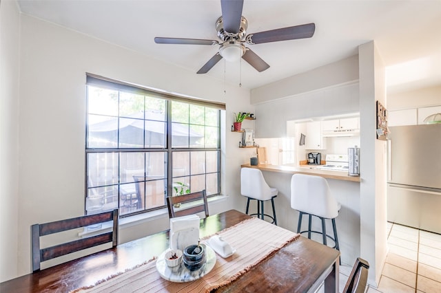 1161 Dallas Dr, Denton, TX 76205 - dining room with ceiling fan and light tile patterned flooring