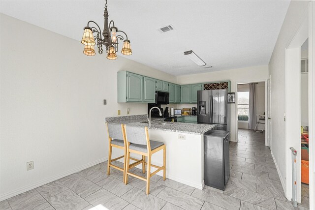 1512 La Paz Dr, Plano, TX 75074 - kitchen with stainless steel fridge, black microwave, a peninsula, green cabinets, and a chandelier