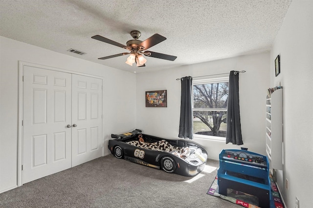 1512 La Paz Dr, Plano, TX 75074 - bedroom featuring carpet floors, a textured ceiling, a closet, and a ceiling fan