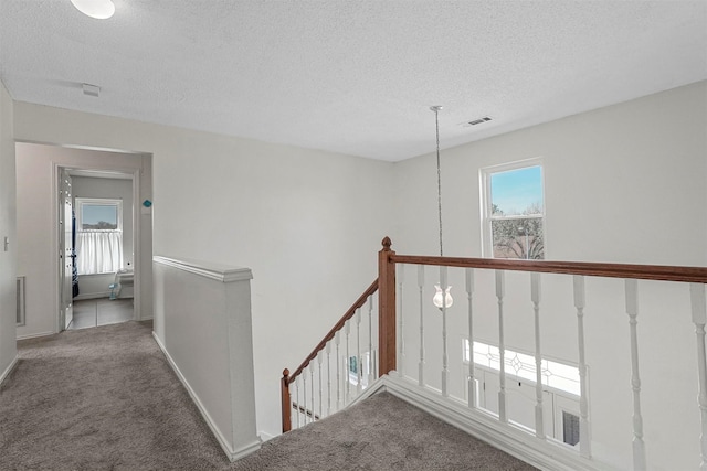 1512 La Paz Dr, Plano, TX 75074 - hall featuring an upstairs landing, carpet, and a textured ceiling