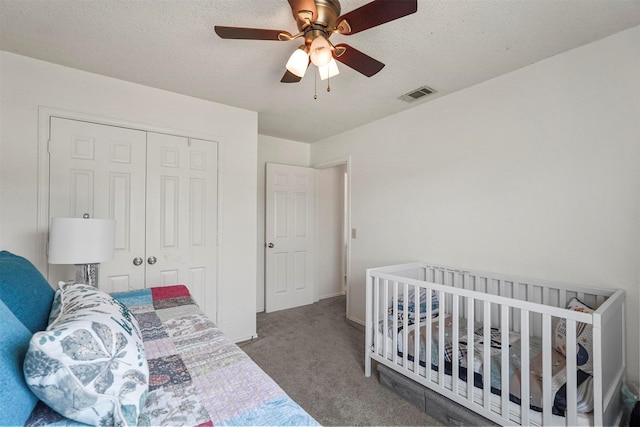 1512 La Paz Dr, Plano, TX 75074 - bedroom with carpet flooring, a closet, a textured ceiling, and a ceiling fan