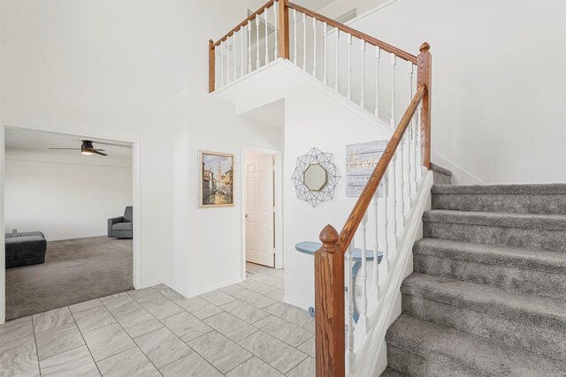 1512 La Paz Dr, Plano, TX 75074 - staircase featuring ceiling fan, carpet floors, and a towering ceiling