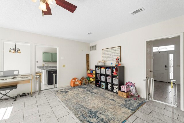 1512 La Paz Dr, Plano, TX 75074 - recreation room with ceiling fan, a textured ceiling, and light marble finish flooring