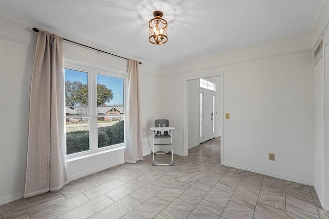 1512 La Paz Dr, Plano, TX 75074 - empty room featuring a textured ceiling, a chandelier, and ornamental molding