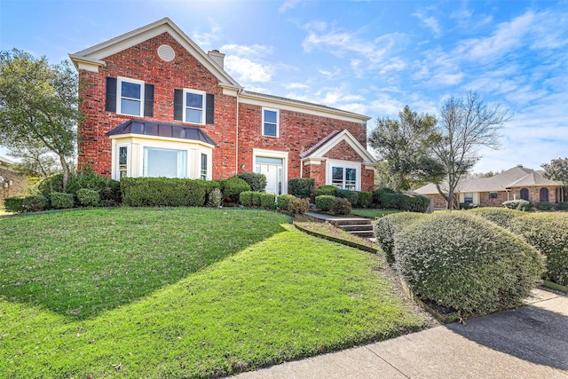 1512 La Paz Dr, Plano, TX 75074 - view of front facade featuring a chimney, brick siding, and a front yard