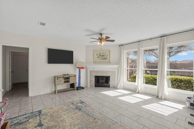 1512 La Paz Dr, Plano, TX 75074 - unfurnished living room with a ceiling fan, a textured ceiling, and a tile fireplace
