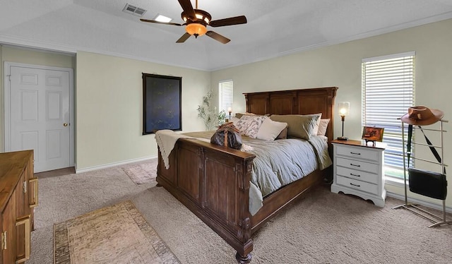 11001 Ridge Point Dr, Woodway, TX 76712 - carpeted bedroom featuring multiple windows, a ceiling fan, and ornamental molding
