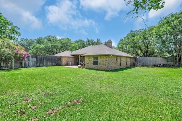 11001 Ridge Point Dr, Woodway, TX 76712 - back of house with brick siding, a fenced backyard, a chimney, and a patio area