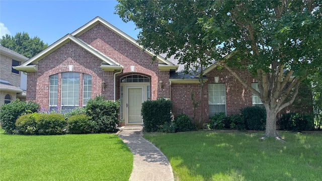 2217 Lone Pecan Dr, Garland, TX 75040 - view of front of home featuring brick siding and a front lawn