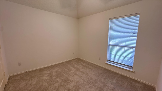 2217 Lone Pecan Dr, Garland, TX 75040 - empty room featuring carpet floors and vaulted ceiling