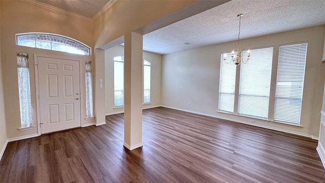 2217 Lone Pecan Dr, Garland, TX 75040 - foyer with dark wood finished floors, plenty of natural light, a chandelier, a textured ceiling, and ornamental molding