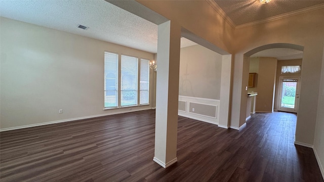 2217 Lone Pecan Dr, Garland, TX 75040 - unfurnished living room featuring arched walkways, dark wood-style floors, a textured ceiling, and ornamental molding