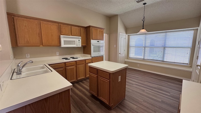 2217 Lone Pecan Dr, Garland, TX 75040 - kitchen featuring white appliances, a textured ceiling, dark wood-style flooring, brown cabinetry, and a center island