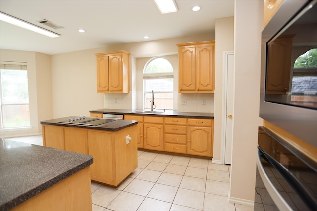 2325 Denham Dr, Arlington, TX 76001 - kitchen with dark countertops, a center island, light brown cabinets, decorative backsplash, and recessed lighting