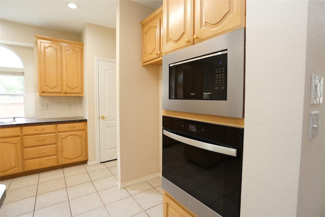 2325 Denham Dr, Arlington, TX 76001 - kitchen featuring oven, light brown cabinetry, built in microwave, light tile patterned floors, and recessed lighting