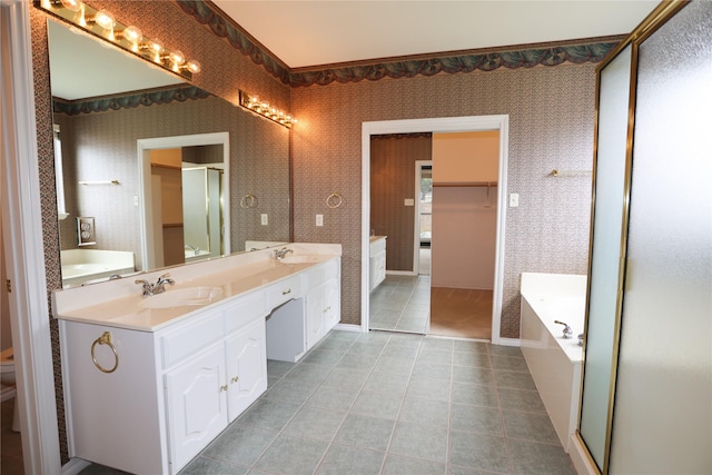 2325 Denham Dr, Arlington, TX 76001 - full bath featuring double vanity, a garden tub, a walk in closet, tile patterned flooring, and wallpapered walls