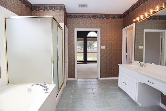 2325 Denham Dr, Arlington, TX 76001 - full bathroom featuring vanity, wallpapered walls, a shower stall, a garden tub, and tile patterned floors