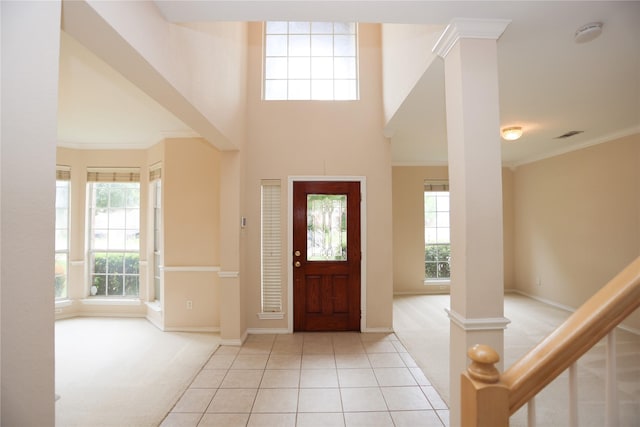 2325 Denham Dr, Arlington, TX 76001 - foyer with crown molding, light tile patterned floors, and light colored carpet