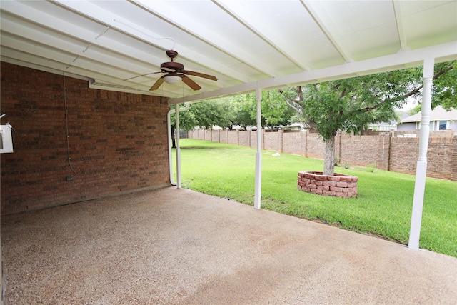 2325 Denham Dr, Arlington, TX 76001 - fenced backyard with ceiling fan and a patio