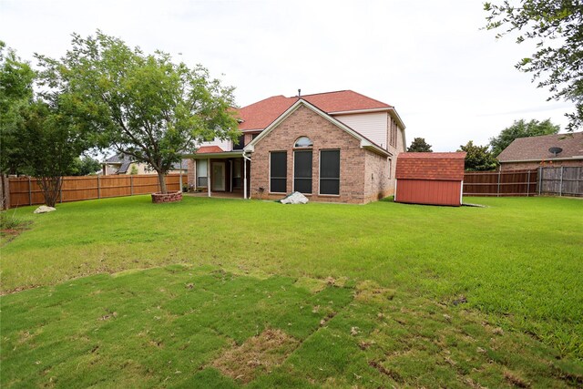2325 Denham Dr, Arlington, TX 76001 - rear view of house featuring a storage shed, a fenced backyard, an outdoor fire pit, and brick siding