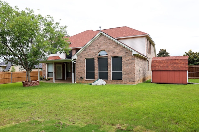 2325 Denham Dr, Arlington, TX 76001 - back of property featuring a fire pit, a storage shed, a fenced backyard, and brick siding