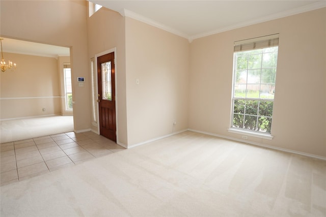 2325 Denham Dr, Arlington, TX 76001 - foyer with light colored carpet, plenty of natural light, a chandelier, crown molding, and light tile patterned floors