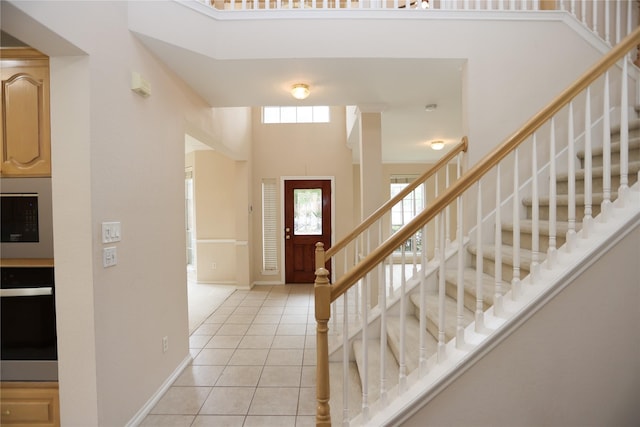 2325 Denham Dr, Arlington, TX 76001 - foyer entrance featuring light tile patterned floors, stairs, and a high ceiling
