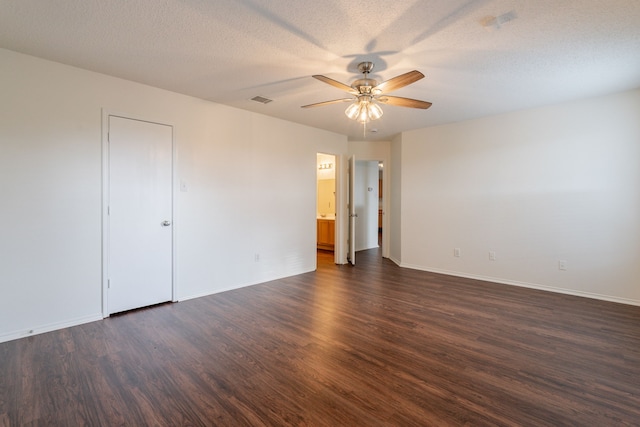 233 Stoneridge Dr, Mesquite, TX 75149 - spare room featuring ceiling fan, dark wood-style floors, and a textured ceiling