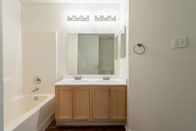 233 Stoneridge Dr, Mesquite, TX 75149 - bathroom with double vanity, bathtub / shower combination, and wood finished floors