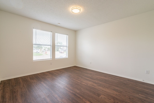 233 Stoneridge Dr, Mesquite, TX 75149 - spare room with dark wood-style flooring and a textured ceiling