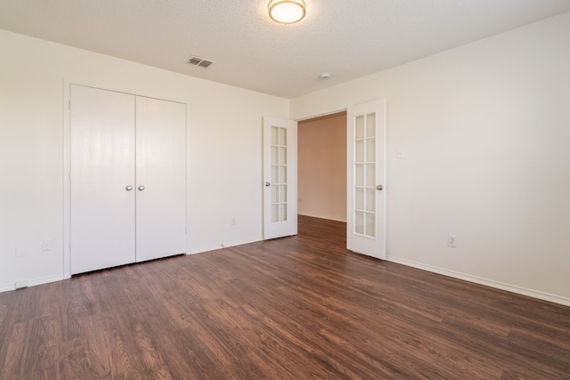 233 Stoneridge Dr, Mesquite, TX 75149 - unfurnished bedroom featuring french doors, wood finished floors, and a closet