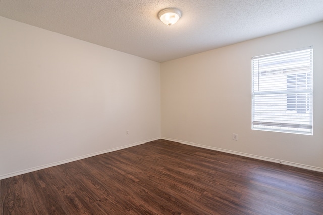 233 Stoneridge Dr, Mesquite, TX 75149 - spare room with dark wood-type flooring and a textured ceiling