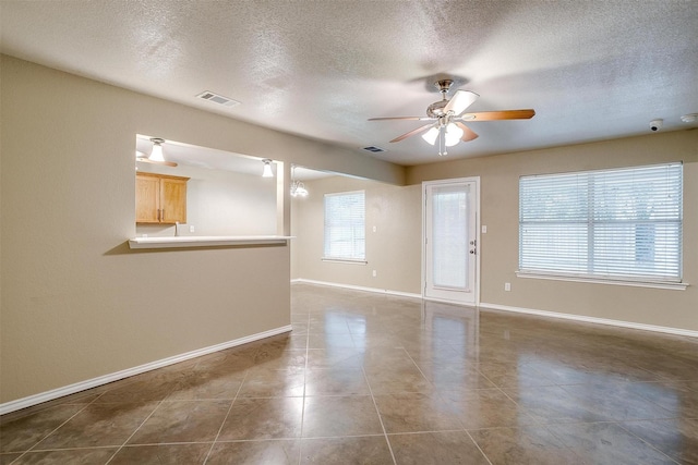 1414 Cheyenne Trl, Granbury, TX 76048 - tiled empty room with a ceiling fan and a textured ceiling