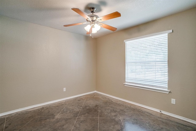 1414 Cheyenne Trl, Granbury, TX 76048 - unfurnished room with a ceiling fan and dark tile patterned flooring