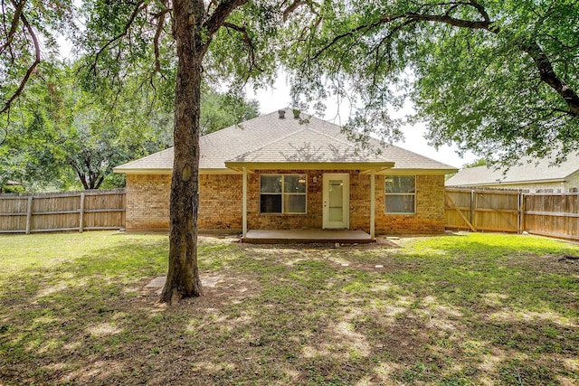 1414 Cheyenne Trl, Granbury, TX 76048 - rear view of house featuring a fenced backyard, a patio, roof with shingles, and brick siding